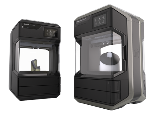 Two MakerBot printers side by side with parts inside